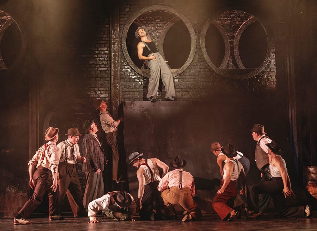 Nicolai Jandorf i toppen med gamblerne i kloakken i Guys and Dolls på Det Ny Teater. Foto: Camilla Winther.